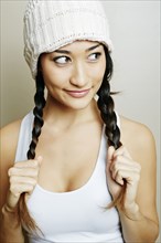 Mixed race woman pulling her pigtails