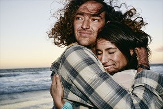 Couple hugging on beach