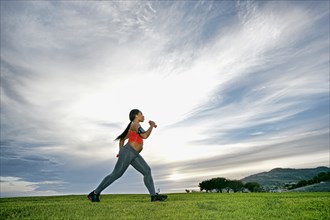 Pregnant woman exercising in park