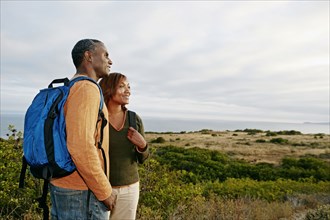 Black couple overlooking rural hillside