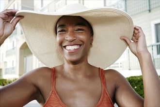 Black woman wearing sun hat outdoors