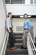 Businessmen standing on staircase