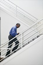Black businessman climbing staircase