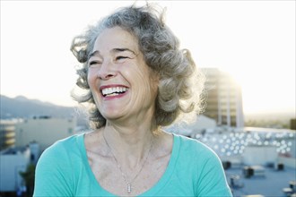 Caucasian woman smiling on urban rooftop