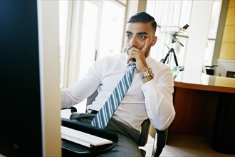 Middle Eastern businessman working at computer in office