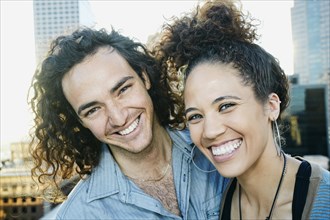 Couple smiling on urban rooftop
