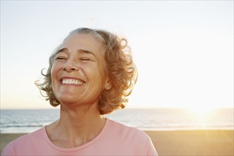 Caucasian woman smiling at beach