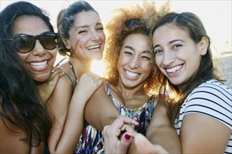 Smiling women taking selfie together outdoors