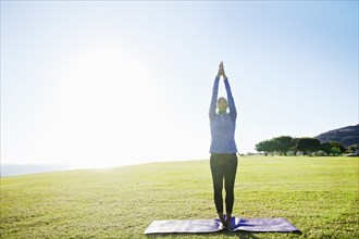 African American woman practicing yoga in park