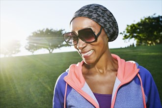 African American woman wearing sunglasses in park