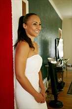 Smiling mixed race woman standing in doorway