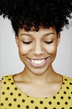 Close up of smiling mixed race woman looking down