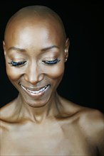 Close up of smiling face African American woman looking down