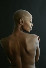 Nude African American woman looking over her shoulder