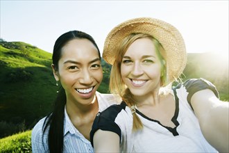 Women taking self portrait on rural hilltop