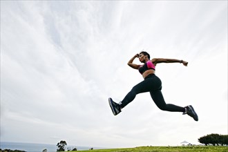 Black woman working out in field