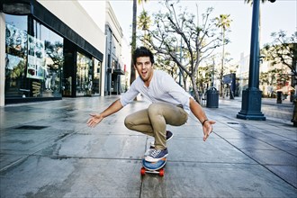 Caucasian man riding skateboard