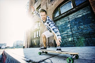 Caucasian man riding skateboard