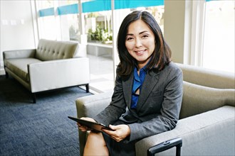Japanese businesswoman using digital tablet in office
