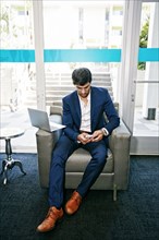 Caucasian businessman using digital tablet in office