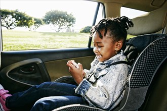 Black girl sitting in car seat