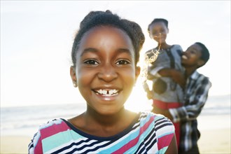 Black girl smiling on beach