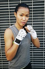Mixed race athlete with raised fists