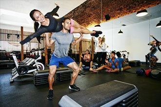 Couple working out in gymnasium