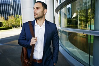 Caucasian businessman walking outside office building