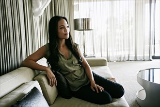 Chinese woman sitting on sofa