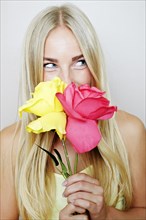 Caucasian woman smelling flowers