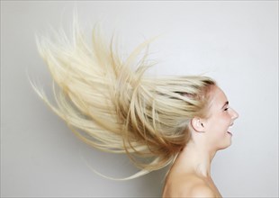 Blonde hair of Caucasian woman blowing in wind