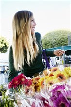 Caucasian woman shopping in flower market