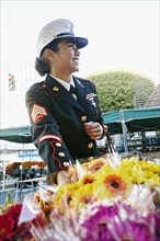Asian soldier shopping in flower market