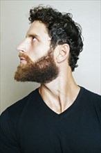 Curious Caucasian man with beard looking up