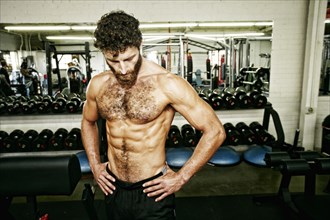 Mixed Race man resting in gymnasium