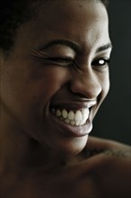 Portrait of Black woman winking