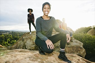 Portrait of smiling women posing on rock formation