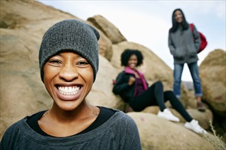 Portrait of smiling women posing on rock formation