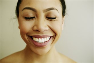 Portrait of smiling Asian woman with eyes closed