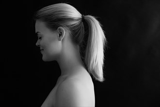 Profile of smiling Caucasian woman with ponytail