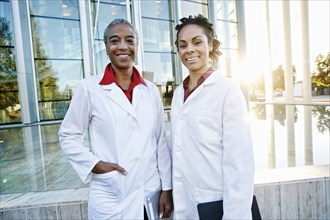 Portrait of smiling doctors outdoors at hospital