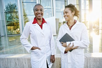 Portrait of smiling doctors outdoors at hospital