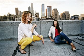 Portrait of smiling women on urban rooftop