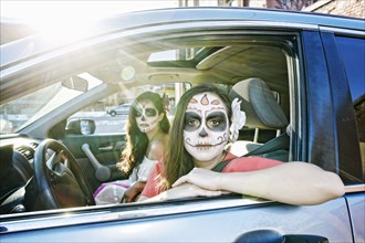 Women in car wearing skull face paint