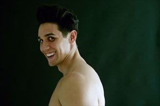 Portrait of naked Caucasian man laughing