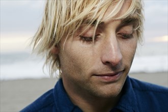 Portrait of pensive Caucasian man at beach