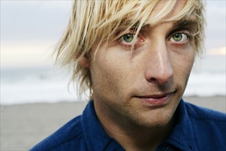 Portrait of serious Caucasian man at beach