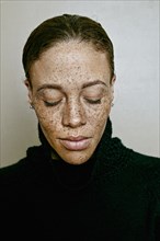 Close up of mixed race woman with eyes closed