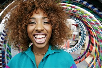Portrait of black woman laughing near hoops